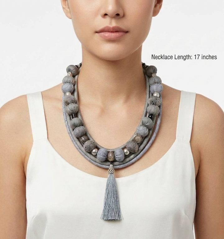 Bohemian-style light gray fabric bead necklace.