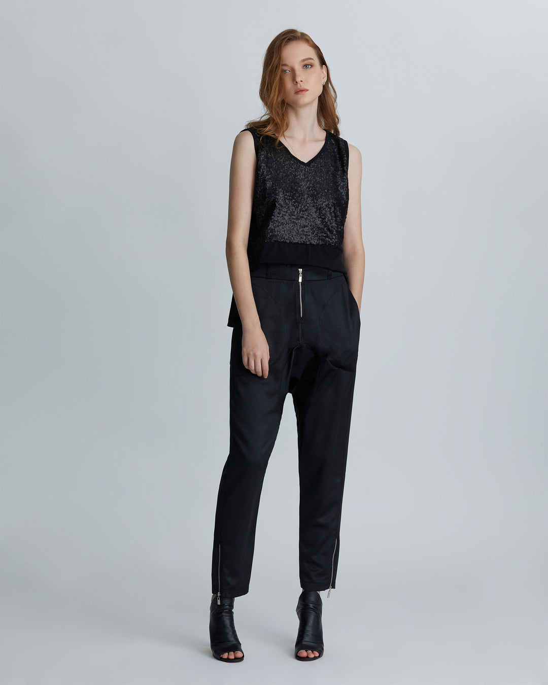 woman wearing the Black high-rise tapered leather embossed lounge pants